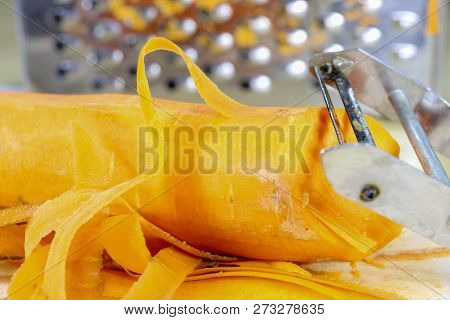 Fresh Carrot Grated On A Metal Kitchen Grate. Vegetables Prepared For Salad With A Meal On The Kitch