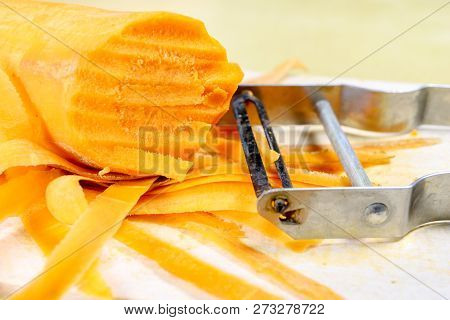 Fresh Carrot Grated On A Metal Kitchen Grate. Vegetables Prepared For Salad With A Meal On The Kitch