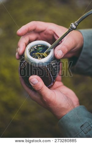 Man Holding Yerba Mate In Nature. Travel And Adventure Concept. Latin American Drink Yerba Mate