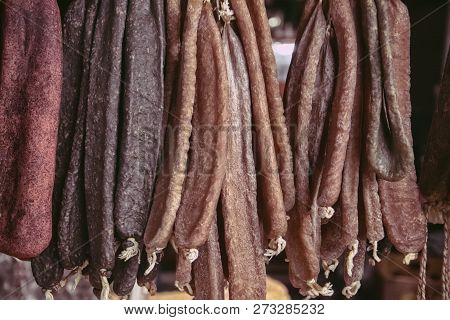 Sujuk And Beef Jerky Hangs On A Counter In The Street Market In The Evening