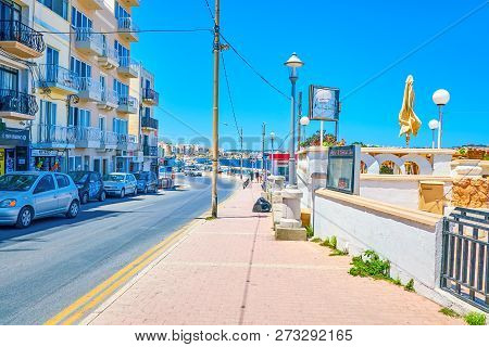 Bugibba, Malta - June 14, 2018: Popular Dawret Il-gzejjer Promenade Is Full Of Ice Cream Shops And C