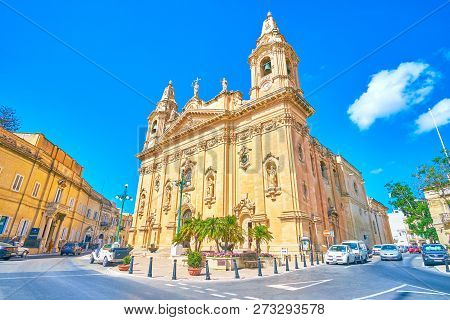 Naxxar, Malta - June 14, 2018: The Traffic In Victory Square In Front Of The Parish Church Of Our La