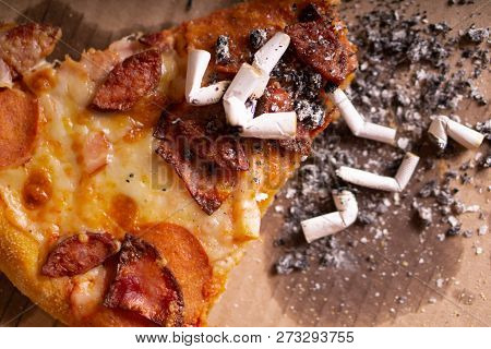 Cigarette Butts In The Remains Of Pizza. The Consequences Of A Drunken Party.