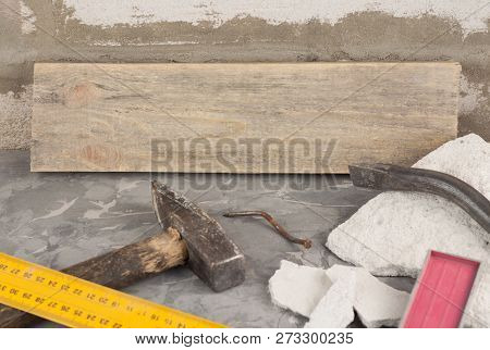 Broken Stone And Dirty Old Hammer With Wooden Handle And Rust Nail And Metal Nail Puller And Yellow 