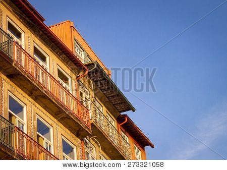 Side View Of The Ceramict Tiled House Facades In Ribeira, Porto, Portugal, Against A Clear Blue Sky 