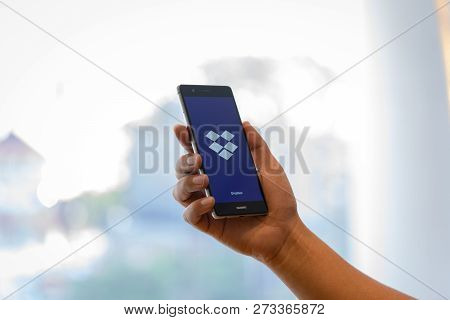Chiang Mai, Thailand - Oct. 28,2018: Man Holding Huawei With Dropbox On Screen. Dropbox Is A Service
