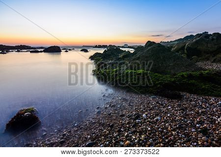 Golden Sunset In Porto, Portugal. Long Exposure Shot On The Rock Beach
