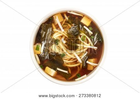 A Photo Of A Bowl Of Miso Soup With Tofu, Scallions, Noodles, Wakame, And Enoki Mushrooms, Shot From