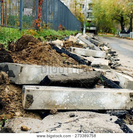 Broken Freshly Dug Up Old Curbstones With Pieces Of An Asphalt And Earth Lying On The Road In Moscow