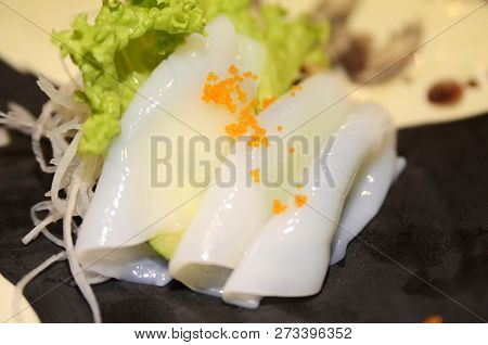 Traditional Japanese Food Ika (squid) Sashimi On Wooden Table