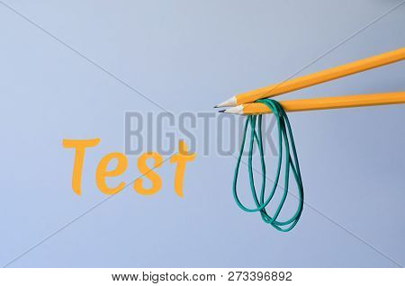 Two Orange Simple Pencils With Green Rubber Bands. Imitation Of Chinese Chopsticks And Noodles.
