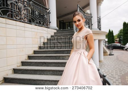 Elegant Lady Satnd On Stairs In Front Of Restaurant