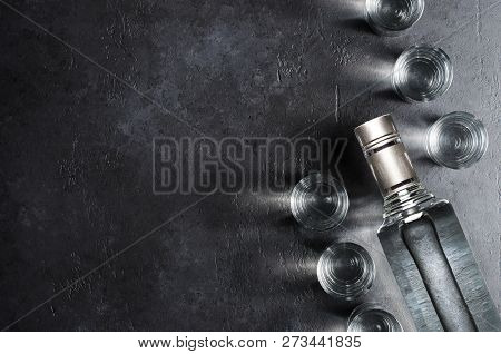 Bottle Of Vodka. Vodka In Glass Glasses. Dark Black Background. Copy Space