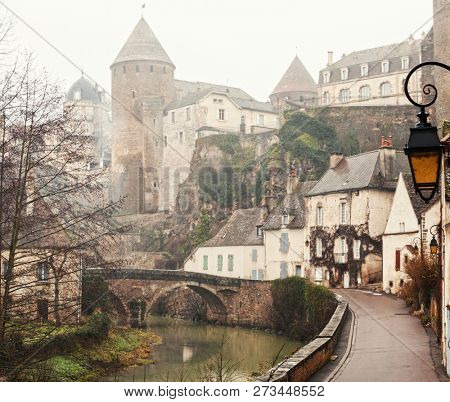 River embankment Armancon at foggy morning in winter,  Semur-en-Auxois, Burgundy, France.