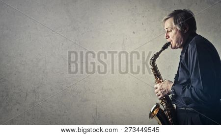 sax musician on grey background