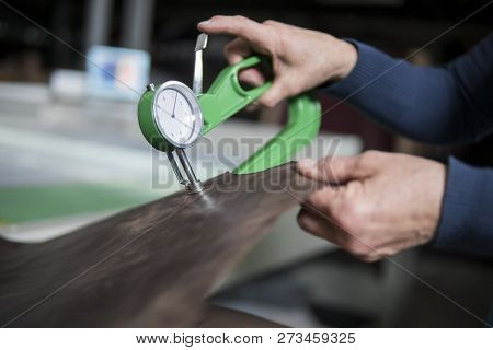Woman Hands Use Leather Thickness Gauge On With A Natural Brown Leather. Preparing Of The Raw Materi
