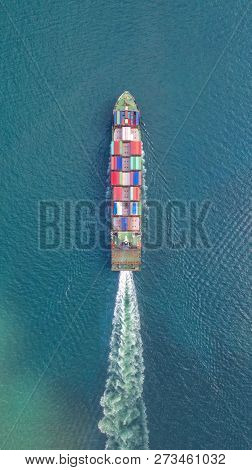 Container Ship In Export And Import Business And Logistics. Shipping Cargo To Harbor By Crane. Water