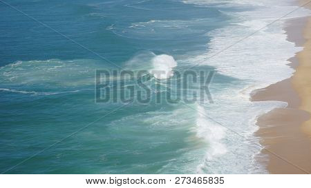 Rough Waves Touching Coast At Nazare In Portugal