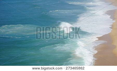 Rough Waves Touching Coast At Nazare In Portugal