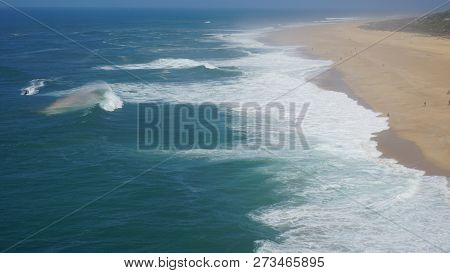 Rough Waves Touching Coast At Nazare In Portugal