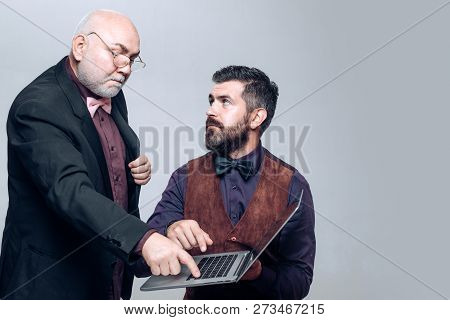 Generations. Age Education. E-learning: Son And Senior Father. Explains How To Use A Laptop. Senior 