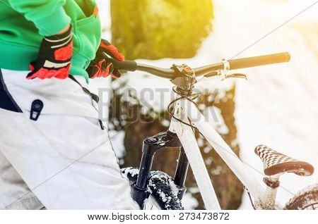 Men Rider Pushes The Extreme Mountain Bike In The Winter Snow-covered Forest. Abstract Extreme Sport