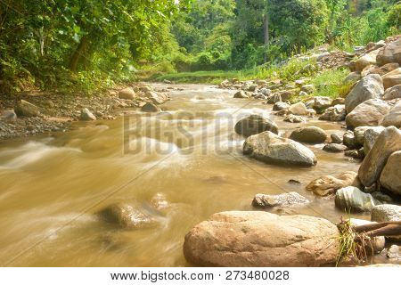 The Beautiful Paniki River With Its Gentle Flow And Brownish Yellow Water During The Rainy Season