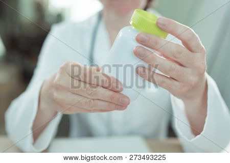 Doctor Recommends Vitamin Supplements, Close Up Of Female General Practitioner Holding A Bottle Of T