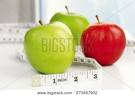 Apple With Tape Measure On White Background Stock Photo