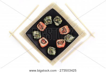 Different Types Of Maki Sushi On A Black Plate