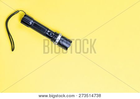Blacc Metal Small Tactical Falshlight Isoltaed On Yellow Background