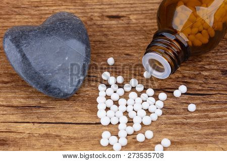 Homeopathy Medicine On Wooden Background.. Shot In Studio