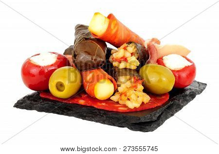 Group Of Tapas Snacks On A Slate Square Isolated On A White Background