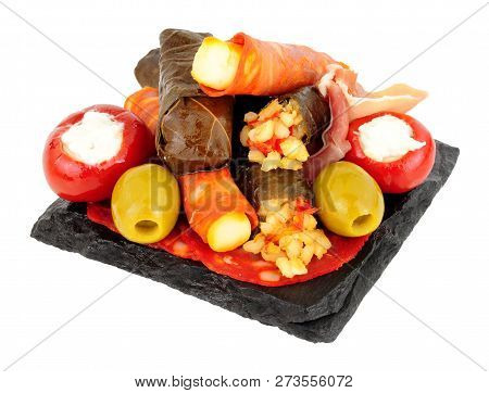 Group Of Tapas Snacks On A Slate Square Isolated On A White Background