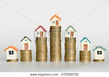 Mini House On Stack Of Coins,money And House,  Mortgage, Savings Money For Buy House And Loan To Bus
