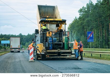 Warsaw, Poland - September 15, 2018: Road Paving Machine On The Road In Poland. Workers At Paver Fin