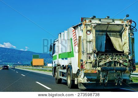 Truck Carrying Trailer With Garbage Container At The Asphalt Road In Slovenia.