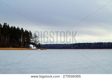 First Snow On The Lake In Late Autumn. Winter Coming Landscape