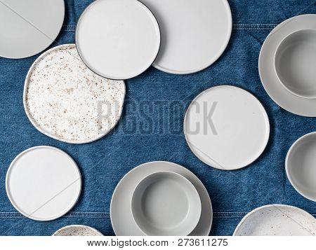 Empty Ceramic Tableware. Ceramic Plates On Jeans Tablecloth Or Runner. Overview Empty Food Table Wit