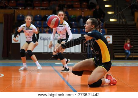 KAPOSVAR, HUNGARY â DECEMBER 2, 2018: Dorottya Kanizsai receives ball at a Hungarian National Championship volleyball game between Kaposvar (white) and Palota VSN (blue) in Sportcsarnok Kaposvar.