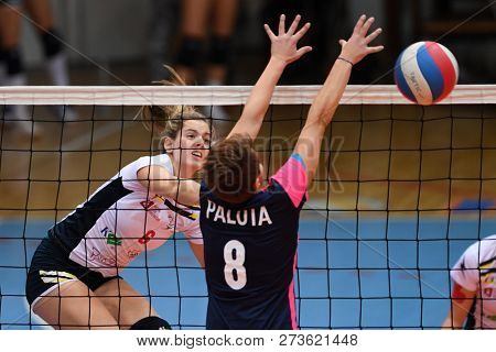 KAPOSVAR, HUNGARY â DECEMBER 2, 2018: Evelin Vacsi (in white) in action at a Hungarian National Championship volleyball game between Kaposvar (white) and Palota VSN (blue) in Sportcsarnok Kaposvar.