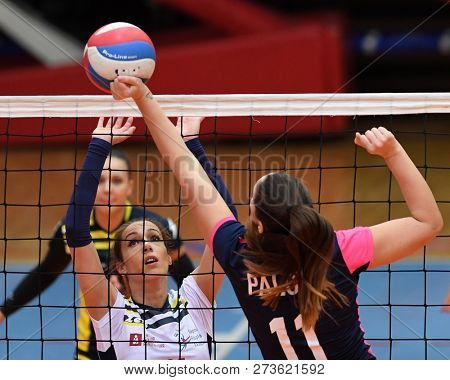 KAPOSVAR, HUNGARY â DECEMBER 2, 2018: Kristina Cesljar (in white) in action at a Hungarian National Championship volleyball game between Kaposvar (white) and Palota VSN (blue) in Sportcsarnok Kaposvar