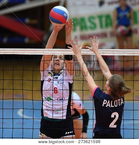 KAPOSVAR, HUNGARY â DECEMBER 2, 2018: Evelin Vacsi (in white) in action at a Hungarian National Championship volleyball game between Kaposvar (white) and Palota VSN (blue) in Sportcsarnok Kaposvar.
