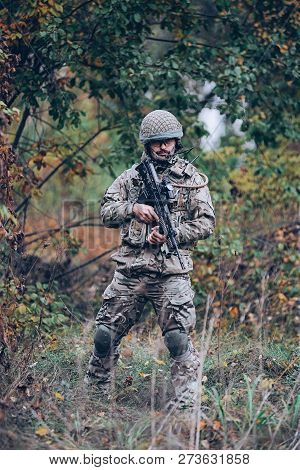 Kyiv, Ukraine - October 14, 2017: Man In Military Uniform With Rifle In His Hands Standing Among The