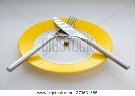 Empty Plate With Fork, Knife And Green Peas