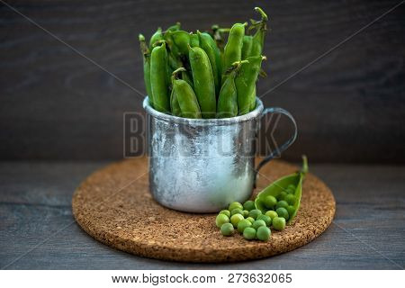 Fresh Green Peas In A Worn Iron Mug