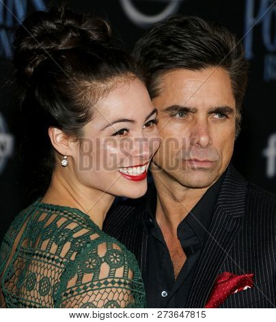 Caitlin Mchugh and John Stamos at the World premiere of Disney's 'Mary Poppins Returns' held at the Dolby Theatre in Hollywood, USA on November 29, 2018.