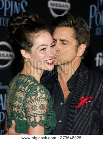 Caitlin Mchugh and John Stamos at the World premiere of Disney's 'Mary Poppins Returns' held at the Dolby Theatre in Hollywood, USA on November 29, 2018.