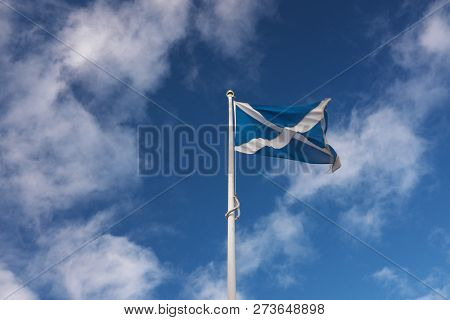 The Scottish Flag (saltire) Flies Against A Deep Blue Sky On A Bright Day. Taken At Edinburgh Castle