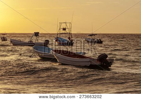 Fishing Boats Drift At Sunrise Off The Coast Of The Caribbean. Mexico